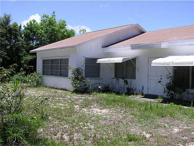5164 Southeast Horseshoe Point Road Stuart, FL 34997 - Photo 2 of 25 a view of a house with a yard and plants