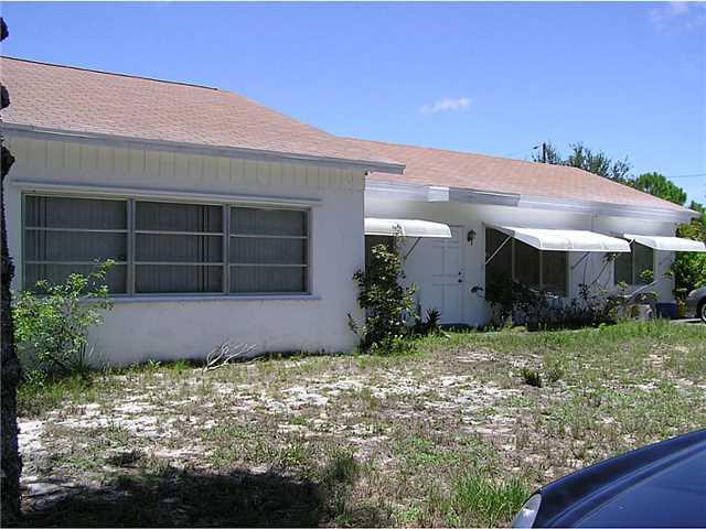5164 Southeast Horseshoe Point Road Stuart, FL 34997 - Photo 4 of 25 a front view of a house with garden