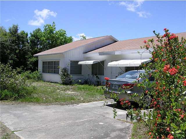 5164 Southeast Horseshoe Point Road Stuart, FL 34997 - Photo 5 of 25 a front view of a house with a yard and potted plants