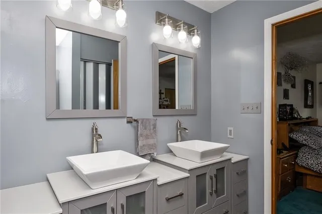a bathroom with 2 sink and a mirror