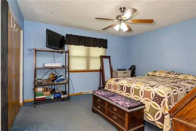 a bedroom with bed and a chandelier