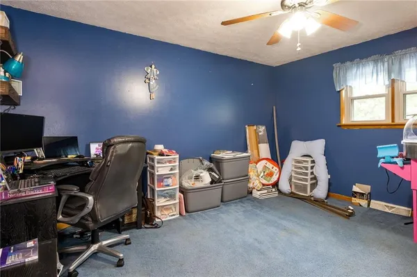a view of a room with workspace and windows