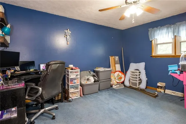 a view of a room with workspace and windows