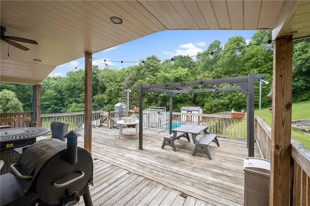 a view of a patio with lawn chairs next to a yard