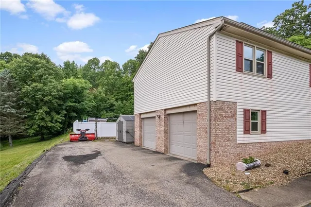 a backyard of a house with wooden floor and fence