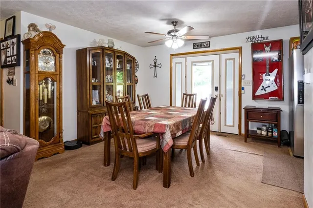 a view of a dining room with furniture and a chandelier