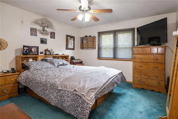 a bedroom with a bed and flat screen tv