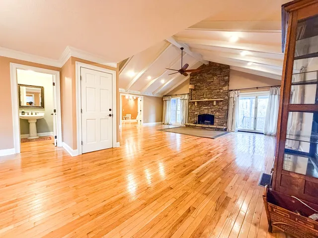 a spacious bedroom with a bed and a mirror