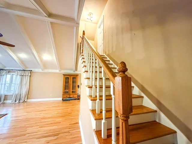 a view of porch with wooden floor and roof with city view