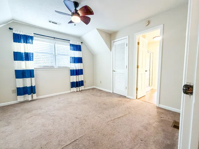 a view of a dining room with furniture and a kitchen