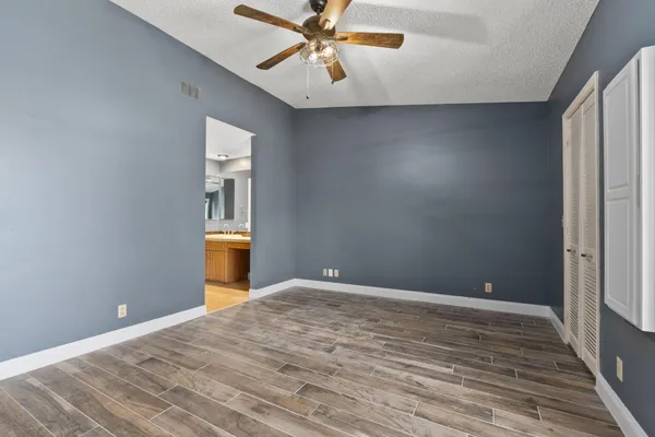 a view of a livingroom with a chandelier fan and a window