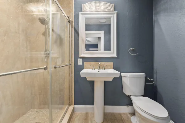 a white toilet sitting next to a bathroom sink