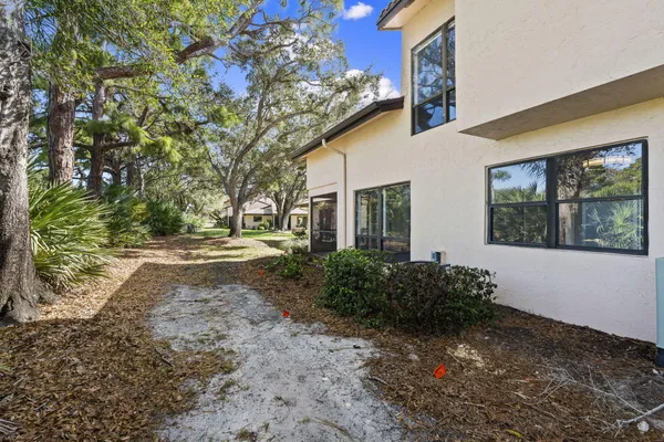 a view of backyard of house with green space