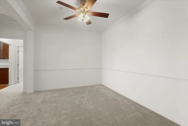 an empty room with a empty space and a ceiling fan