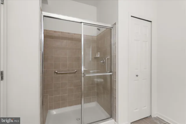 a bathroom with a glass shower door