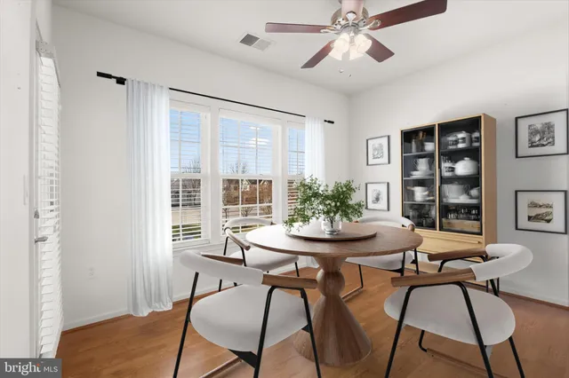 a view of a dining room with furniture and window
