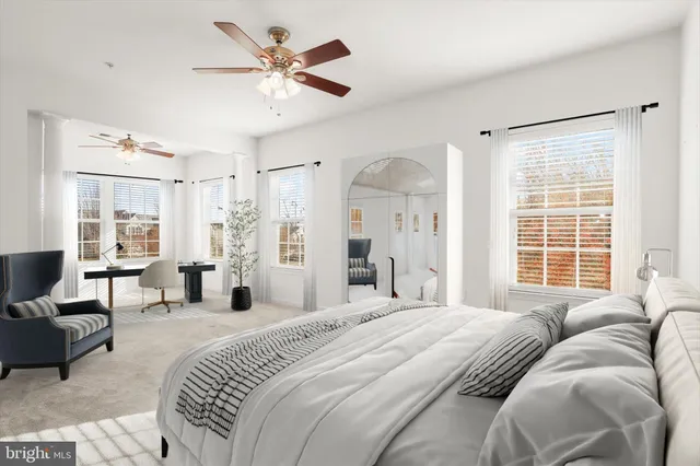 a spacious bedroom with a bed and a couch