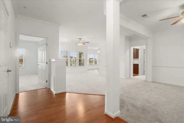 a view of a big room with wooden floor and a bathroom