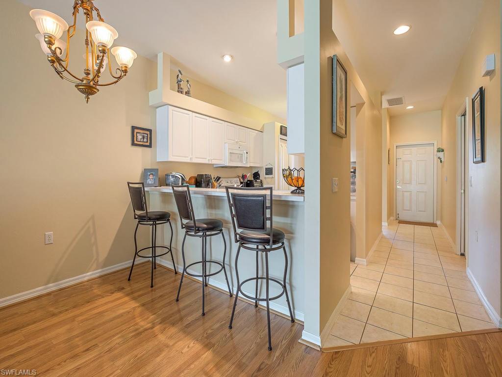 1728 Morning Sun Lane, Unit D8 Naples, FL 34119 - Photo 6 of 12 a view of a dining room with furniture and wooden floor