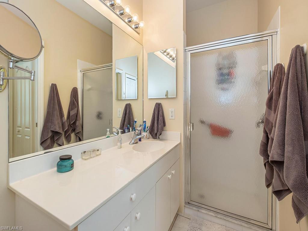 1728 Morning Sun Lane, Unit D8 Naples, FL 34119 - Photo 9 of 12 a bathroom with a sink and a mirror