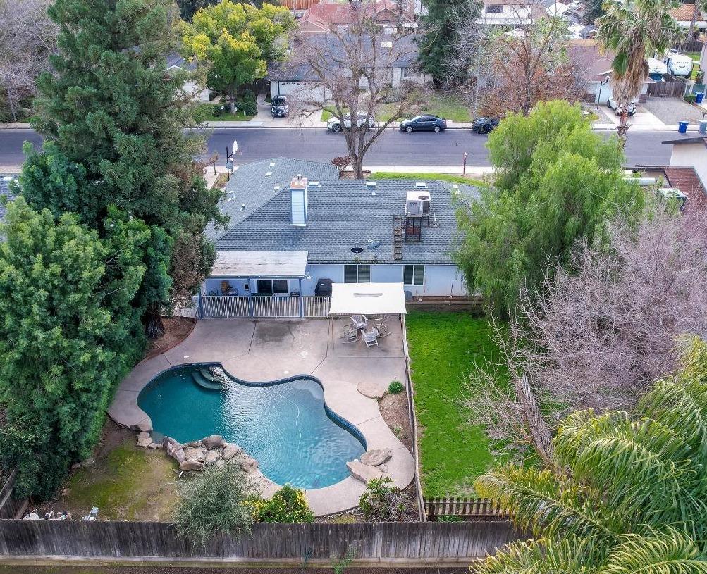 an aerial view of a house with garden space and lake view