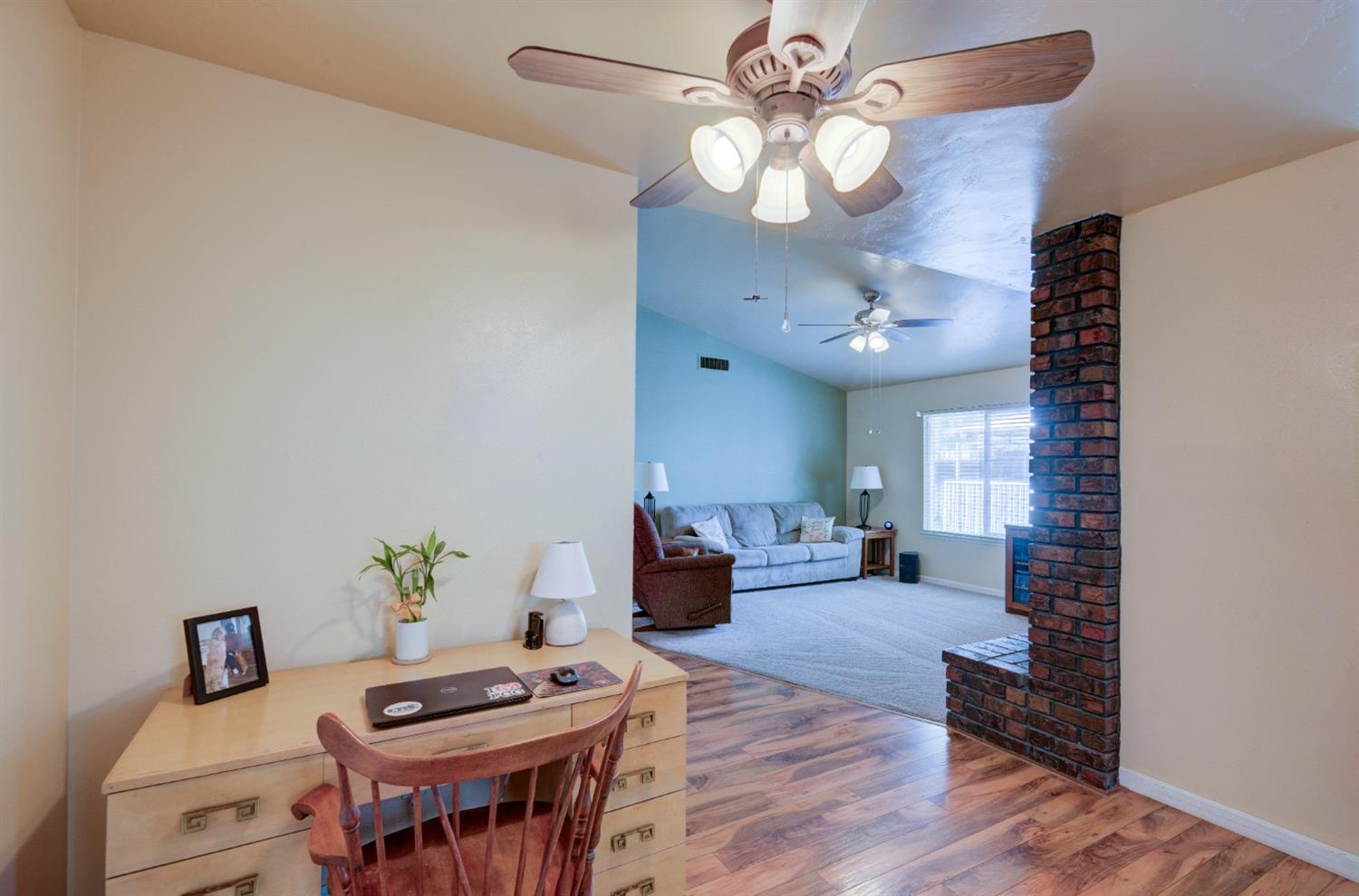 695 West Polson Avenue Clovis, CA 93612 - Photo 12 of 27 a living room with furniture and a chandelier