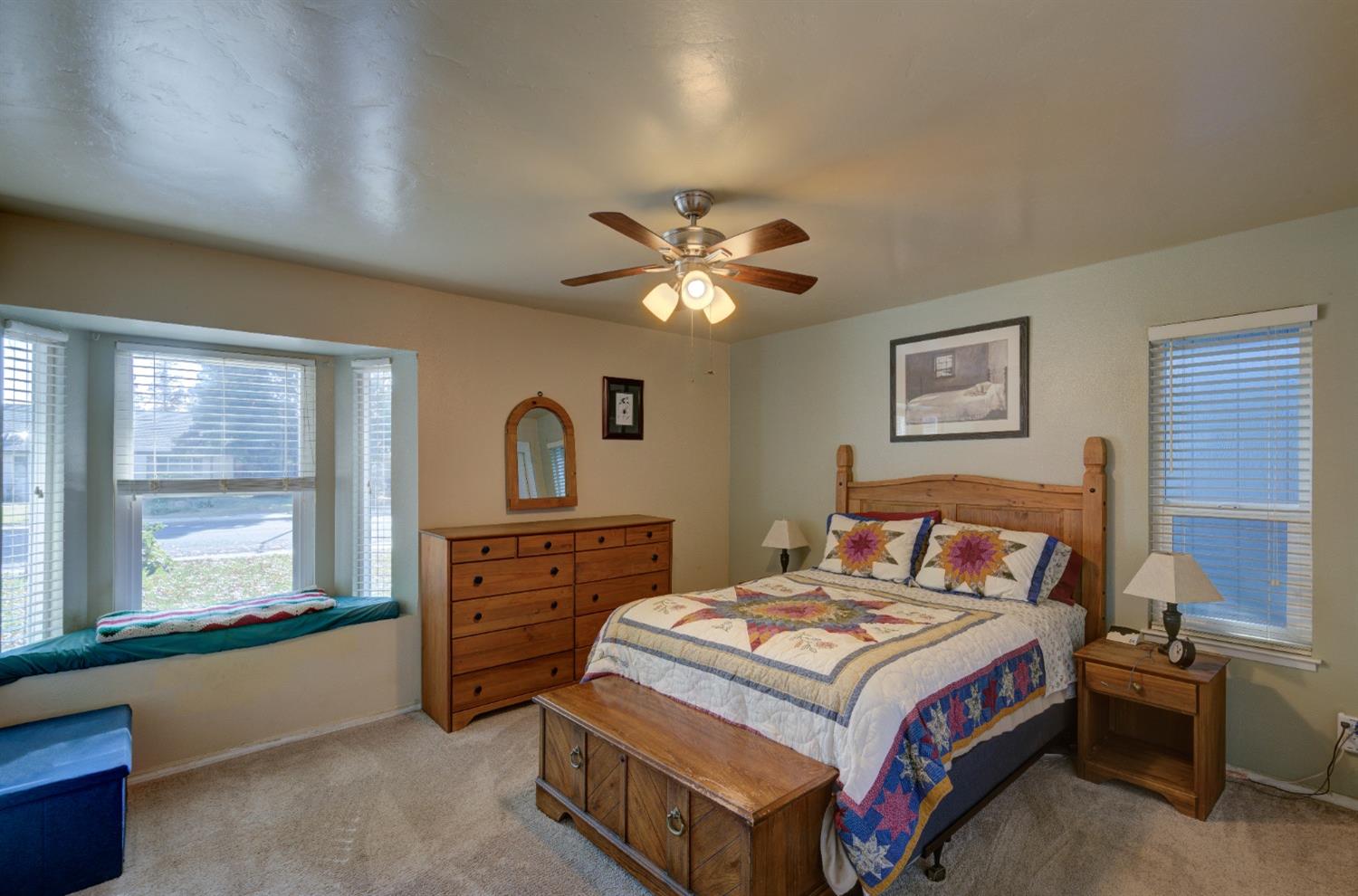 695 West Polson Avenue Clovis, CA 93612 - Photo 15 of 27 a bedroom with a bed and a large window with a chandelier