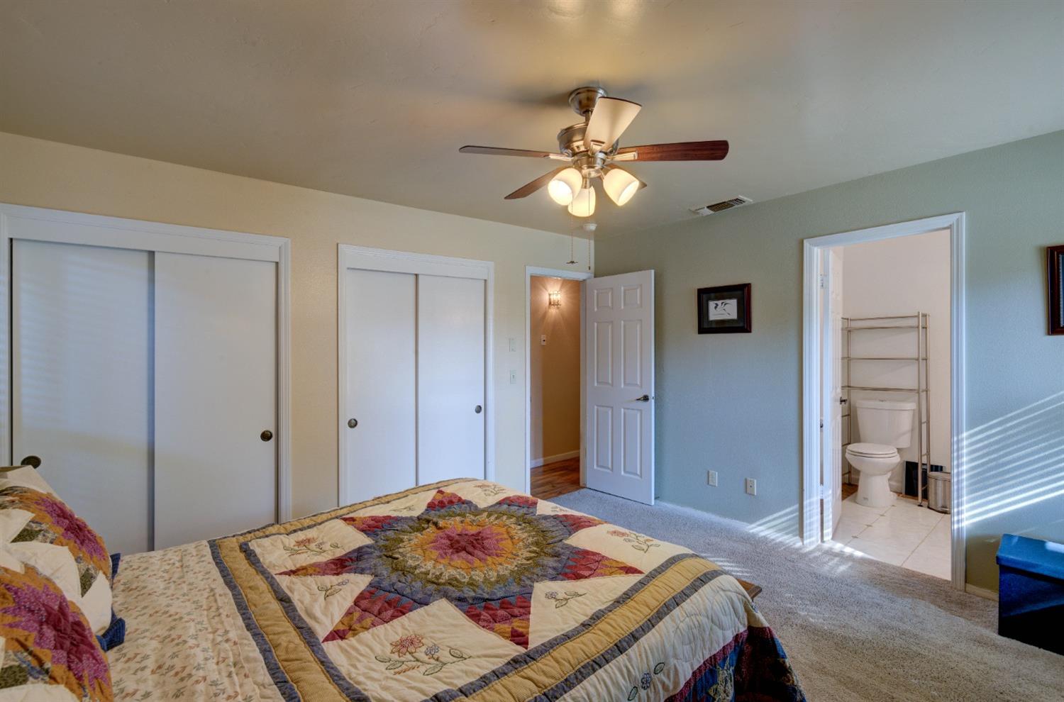 695 West Polson Avenue Clovis, CA 93612 - Photo 16 of 27 a bedroom with a bed and a chandelier