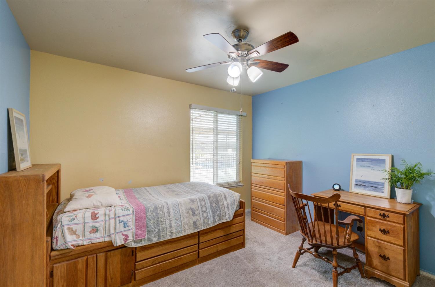 695 West Polson Avenue Clovis, CA 93612 - Photo 17 of 27 a bedroom with a bed and a chandelier