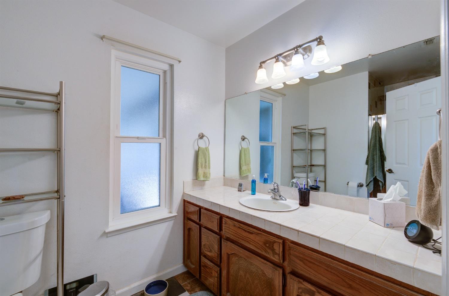 695 West Polson Avenue Clovis, CA 93612 - Photo 20 of 27 a bathroom with a double vanity sink and a mirror