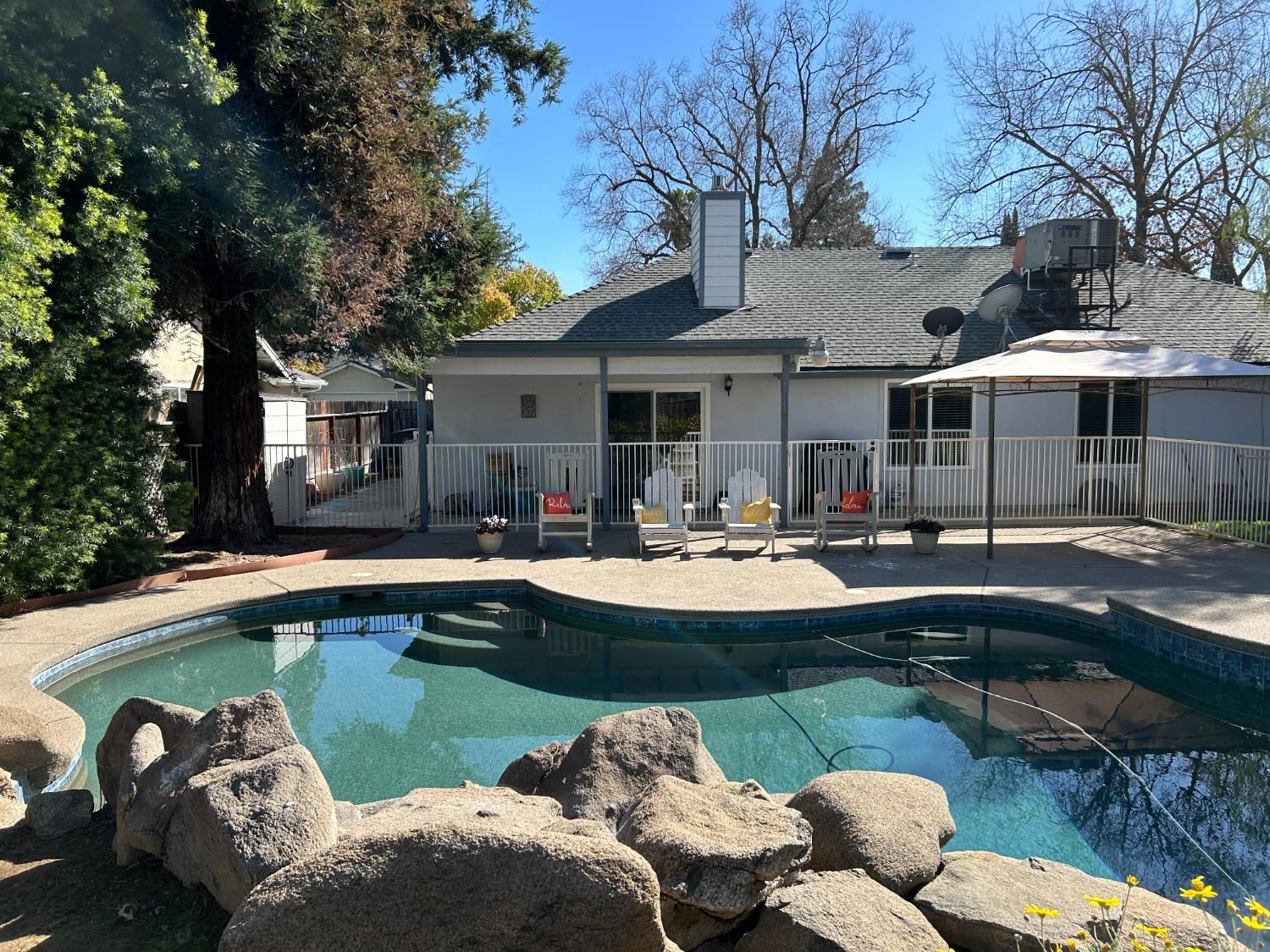 695 West Polson Avenue Clovis, CA 93612 - Photo 2 of 27 a front view of house with swimming pool yard and outdoor seating