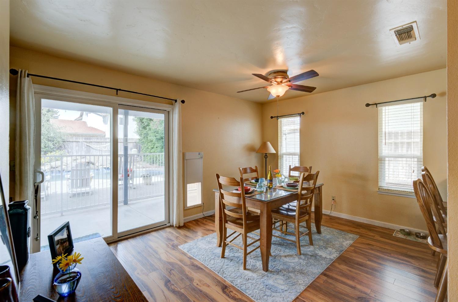 695 West Polson Avenue Clovis, CA 93612 - Photo 9 of 27 a view of a dining room with furniture window and wooden floor