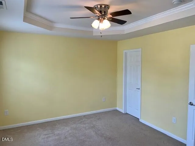 a view of a room with a chandelier fan and a ceiling fan