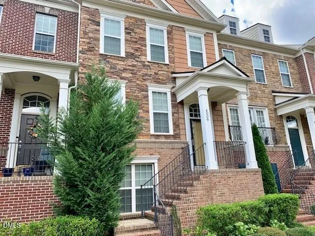 front view of a brick house with a large windows