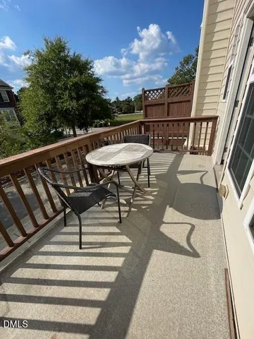 a view of balcony with wooden floor and outdoor seating
