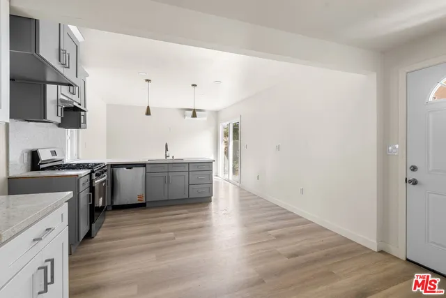 a kitchen with a sink and a stove top oven