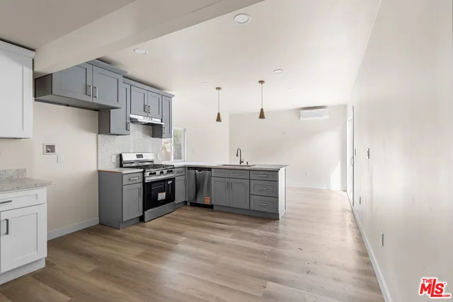 a large kitchen with a stove top oven