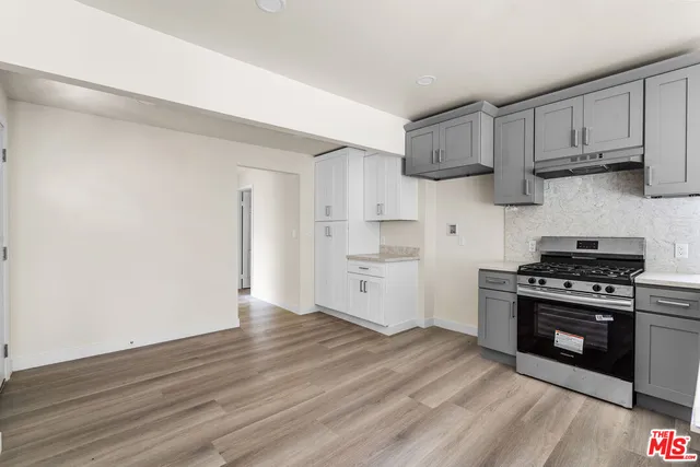 a kitchen with stainless steel appliances granite countertop a stove and a refrigerator