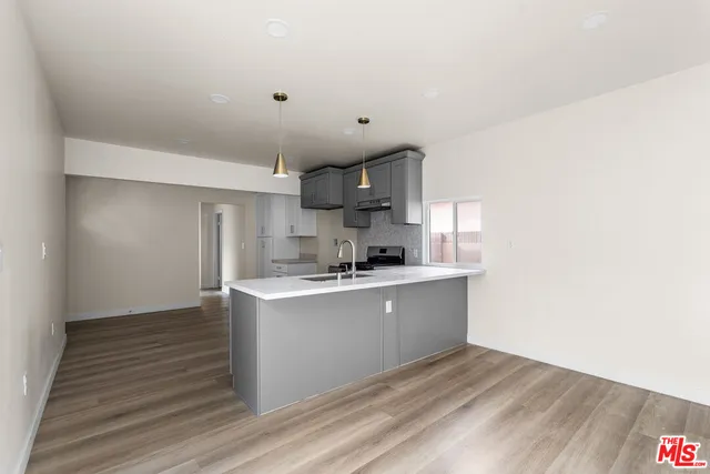 a kitchen with stainless steel appliances granite countertop a sink stove and cabinets