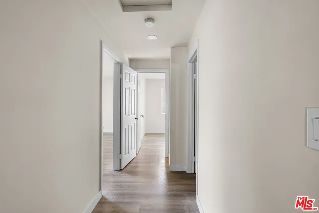 a view of a hallway with wooden floor