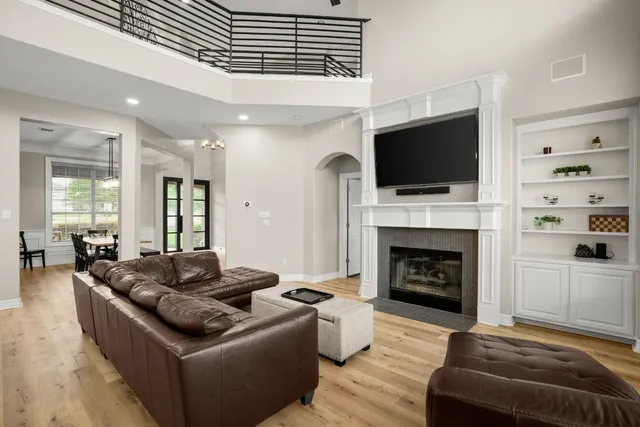 a living room with furniture and a wooden floor
