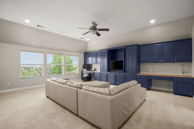 a view of a room with wooden floor and windows