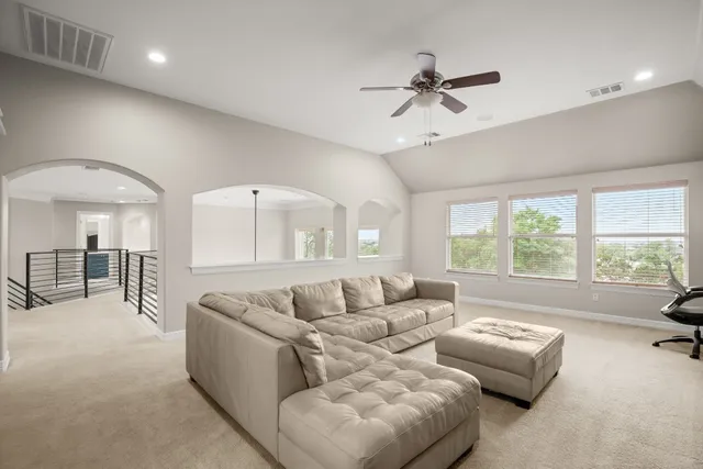 a living room with furniture fireplace and a large window
