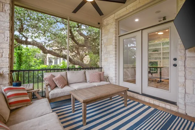 a hallway with wooden floor and windows