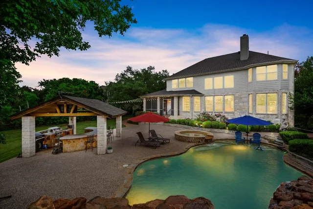 a living room with large windows and a table