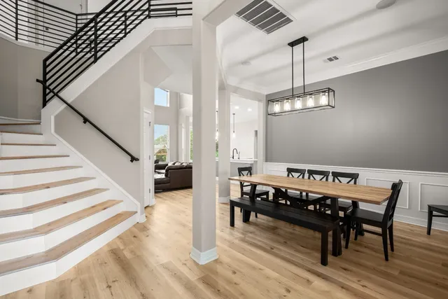 a view of a dining room with furniture wooden floor and chandelier
