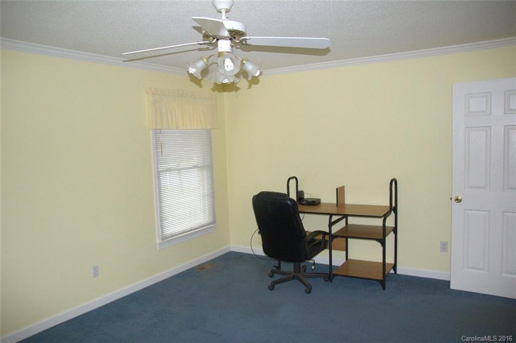 2710 Blue Jay Road Heath Springs, SC 29058 - Photo 12 of 21 a view of a workspace with furniture and a chandelier fan