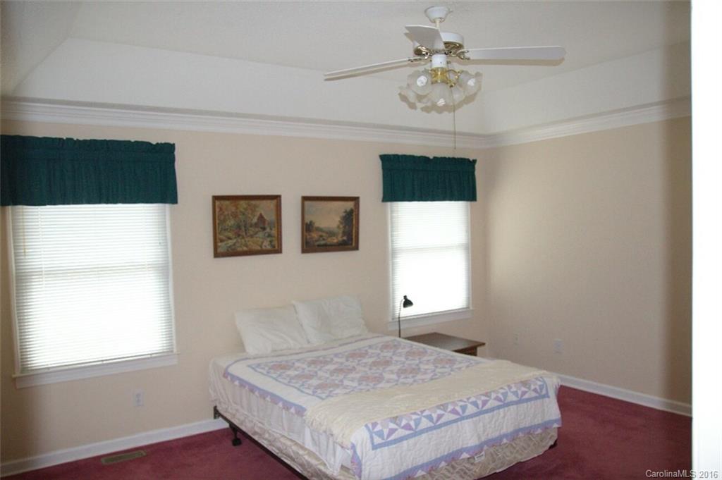 2710 Blue Jay Road Heath Springs, SC 29058 - Photo 14 of 21 a bedroom with a bed and a chandelier