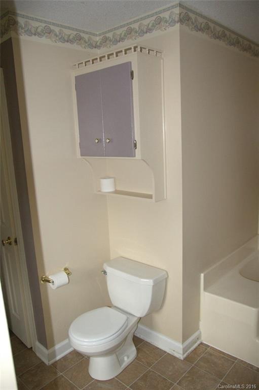 2710 Blue Jay Road Heath Springs, SC 29058 - Photo 18 of 21 a white toilet sitting next to a bath tub