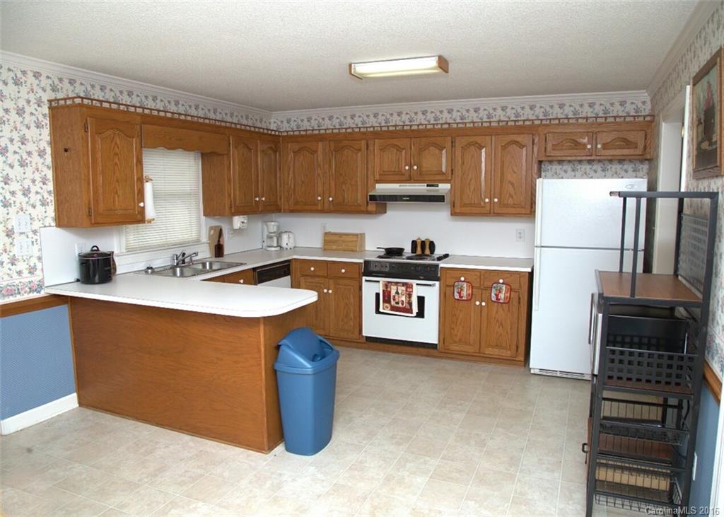 2710 Blue Jay Road Heath Springs, SC 29058 - Photo 9 of 21 a kitchen with stainless steel appliances granite countertop a sink stove and refrigerator